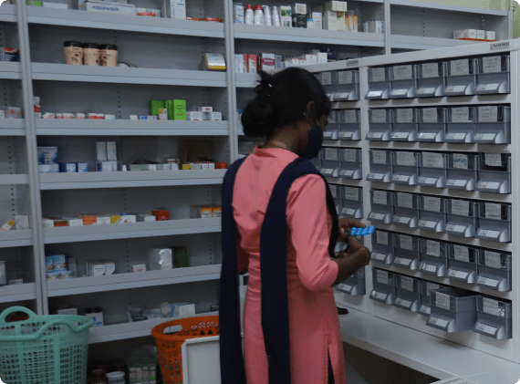 A women standing infront of Allchemist Medical Racks or Pharmacy Racks