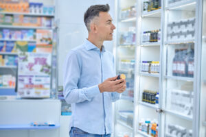 A man choosing medicines in a drugstore